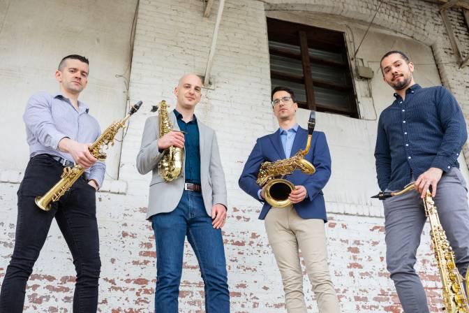 the quartet quartet posing with their saxophones